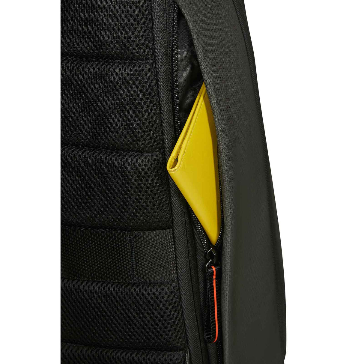 Close-up of a dark Green backpack showing a side mesh pocket and a zippered compartment with a bright yellow item partially tucked inside, on a white background.