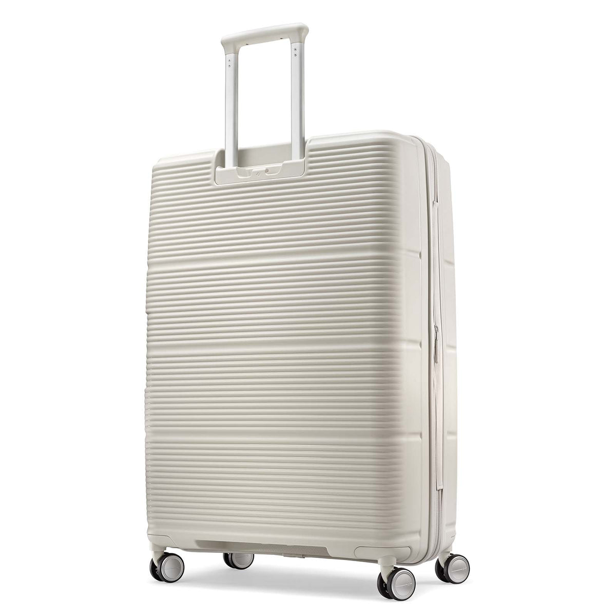 A cream-colored hardshell spinner suitcase with a textured horizontal ribbed pattern, featuring an extended telescoping handle and four multi-directional wheels, shown on a plain white background.