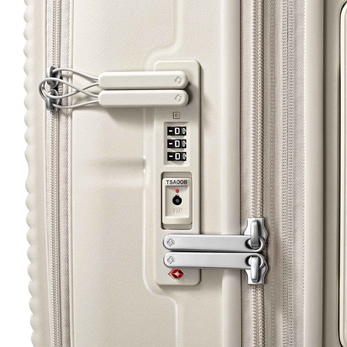 Close-up of a hard-shell suitcase lock area showing a TSA-approved combination lock, a small padlock, and a silver latch on a light beige/cream suitcase.