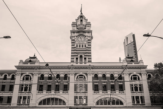 Historic Flinders Street Station building with clock tower and modern skyscraper in the background