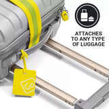 Yellow luggage tag attached to a suitcase with text indicating it can attach to any type of luggage.