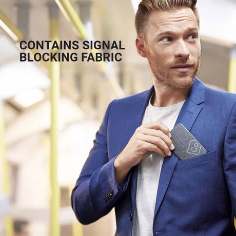 Man in a blue jacket holding an RFID card holder in an indoor setting.