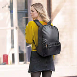 Woman wearing a black backpack in an urban setting