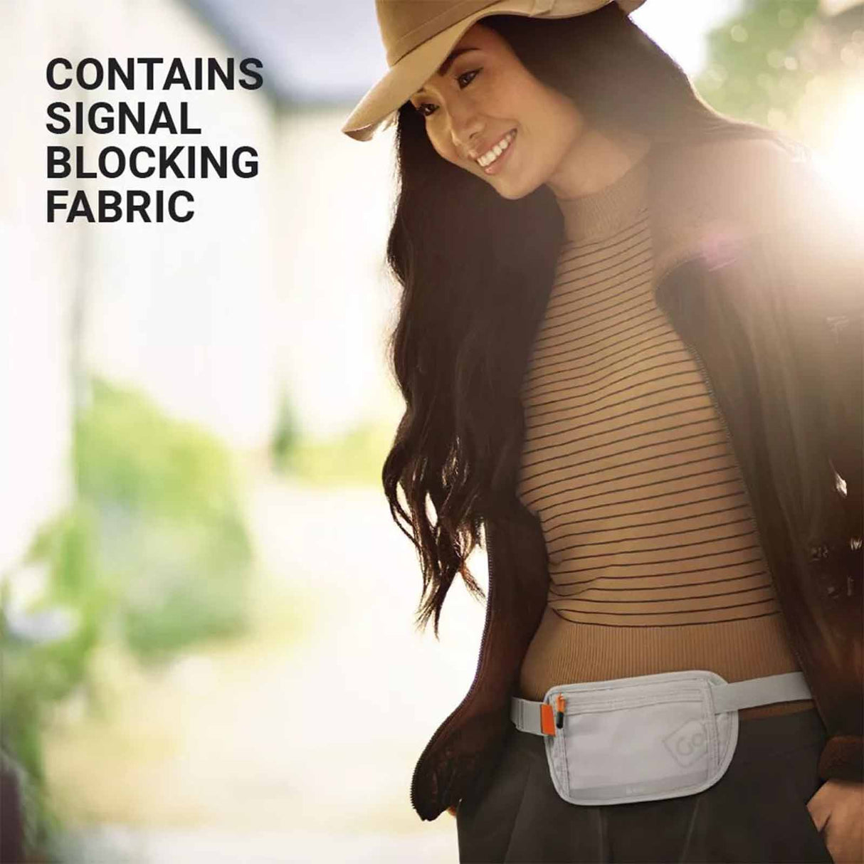 Woman wearing a brown top with text about signal blocking fabric, outdoors.