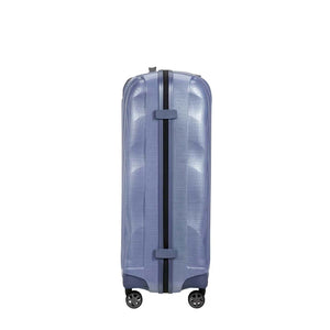 Lavender Samsonite suitcase with black straps on a white background