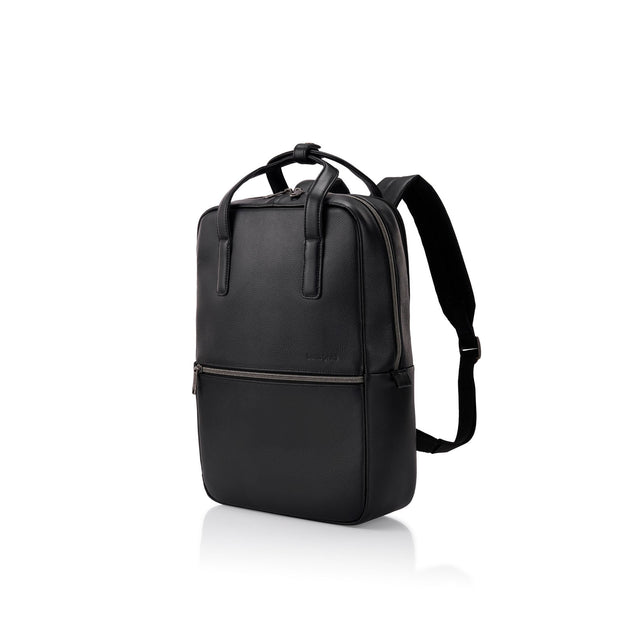 A black leather backpack with dual top handles, a front zippered pocket, and adjustable shoulder straps, shown from a three-quarter angle on a white background.