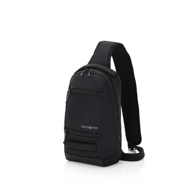 A black Samsonite brand sling backpack with a single shoulder strap and multiple zippered compartments, shown from a three-quarter angle on a solid white background.