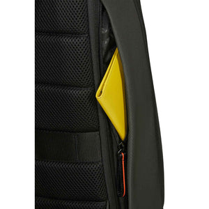 Close-up of a dark Green backpack showing a side mesh pocket and a zippered compartment with a bright yellow item partially tucked inside, on a white background.