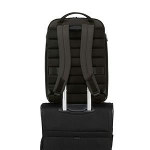 Dark Green backpack shown from the back, resting on top of a black rolling suitcase against a plain white background.