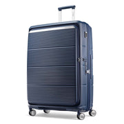 A navy blue hardshell spinner suitcase with a ribbed front panel and silver zippers, shown on a clean white background.