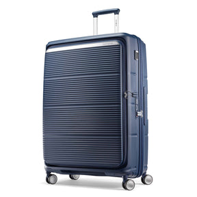 A navy blue hardshell spinner suitcase with a ribbed front panel and silver zippers, shown on a clean white background.