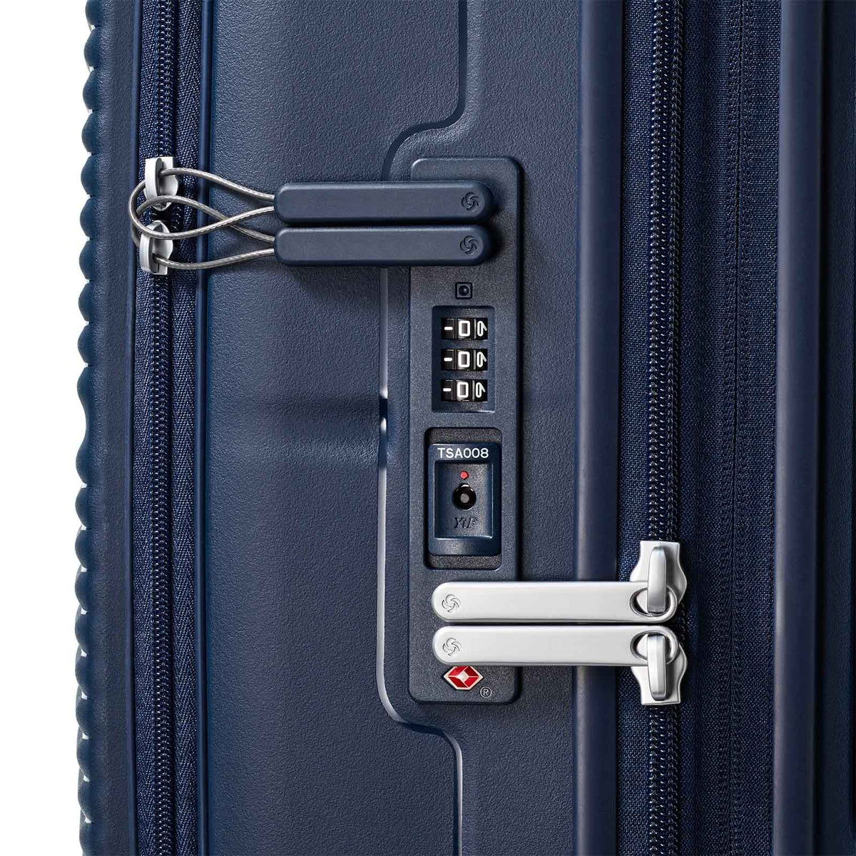 Close-up of a navy blue suitcase with TSA lock and combination lock on a white background