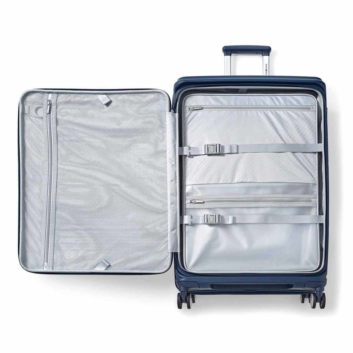 A navy blue hard-shell suitcase shown open from a top-down view, revealing a light gray interior organizer with zippered compartments and elastic straps.