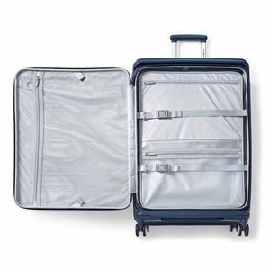 A navy blue hard-shell suitcase shown open from a top-down view, revealing a light gray interior organizer with zippered compartments and elastic straps.