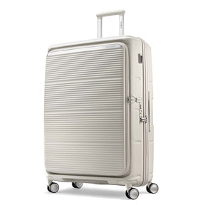 A cream-colored hardshell spinner suitcase with a ribbed front panel, shown on a clean white background.