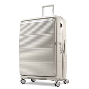 A cream-colored hardshell spinner suitcase with a ribbed front panel, shown on a clean white background.