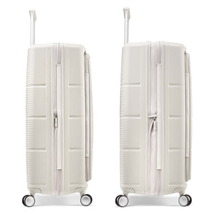 Two hard-shell spinner suitcases in a light warm off-white color, shown side by side against a plain white background.