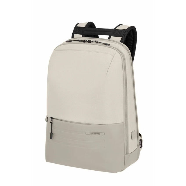 A light beige backpack with black mesh shoulder straps and black zipper pulls, shown from a three-quarter angle on a solid white background.