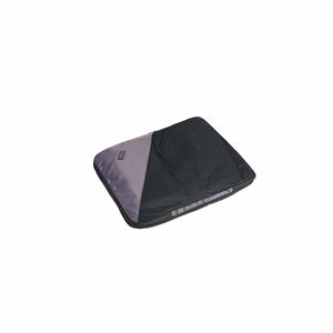A small black compression cube for packing or organizing, with a visible brand tag.
