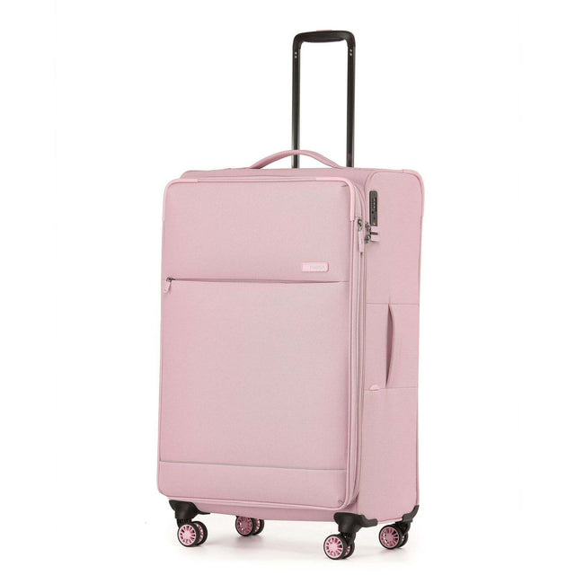 A light pink softside spinner suitcase with an extended black telescoping handle, shown on a plain white background.