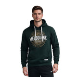 Man wearing a green hoodie with 'Melbourne' text on a white background